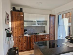 a kitchen with wooden cabinets and a counter top at Chalet 37 Oberland in Gaflenz