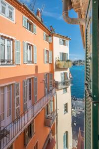 a view of the ocean from a building at Le Duplex in Villefranche-sur-Mer
