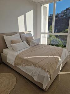 a bed in a room with a large window at Noahs Paradise in Benissa