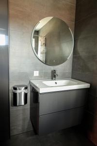 a bathroom with a sink and a mirror at Hotel Royal in IJmuiden