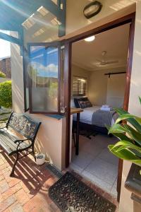a bedroom with a bed and a glass door at Dolphin Circle Bed and Breakfast in Plettenberg Bay +34 photos