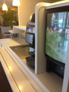 a refrigerator with a video game inside of it at Ibis Budget Rambouillet in Rambouillet