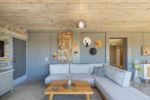 a living room with a couch and a table at Vitamine Sea House - Island Living Paros in Parasporos