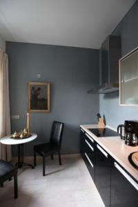 a kitchen with a counter and a table and chairs at Apartmenthaus Saxonia in Bad Schandau