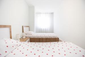 Postel nebo postele na pokoji v ubytování Dodona ApartHotel in Prishtina