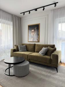 a living room with a couch and a table at Boutique Apartment - Široki Brijeg in Široki Brijeg