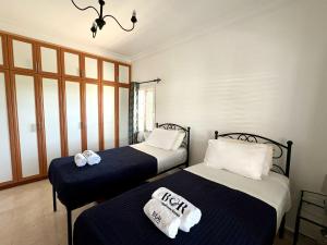 two beds in a room with blue and white sheets at Villa Tanyeli with Private Pool and Terrace in Lapithos