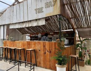 a restaurant with stools and a chef in the kitchen at NOMAD Home & Coffee in Da Lat +54 photos