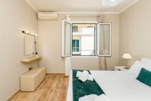 Postel nebo postele na pokoji v ubytování Corfu Town Getaway