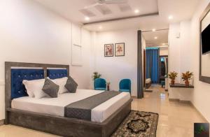 a bedroom with a bed and chairs in a room at The Cloudberry Kasauli I Guaranteed Best Price I Serviced Villa I Open Air Rooftop I Couple Friendly I Pvt Balcony I Kasauli By ExoticStays in Kasauli