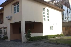 a white building with a courtyard in front of it at The Vistana 4Bedroom Pearly Gate Estate Ikota VGC Lekki in Igboshere