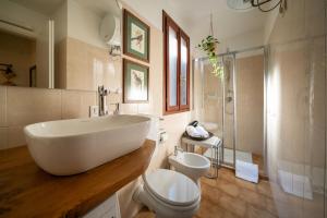 a bathroom with a large white sink and a toilet at Via Cesarini Apartment in San Vito al Tagliamento +15 photos