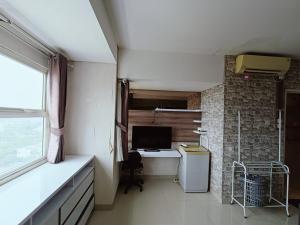 a room with a desk with a computer and a window at Chiens168 in Cikarang