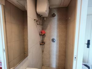 a bathroom with a shower with a toilet in it at Chiens168 in Cikarang