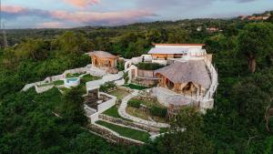 an aerial view of a house in the forest at Camanta Penida - Panoramic Sea & Romantic Escape in Nusa Penida