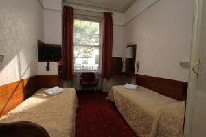 Un pat sau paturi într-o cameră la Ridgemount Hotel