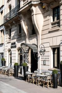 a row of tables and chairs in front of a building at Grand Hôtel Champs-Elysées in Paris