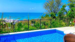 a swimming pool with a view of the ocean at -Villa Rikyu- 離宮 in Miyako-jima