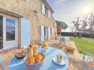 a table with bread and fruit on top of a house at Le Mas Valou, villa en pierre dans les hauteurs de Fayence in Tourrettes