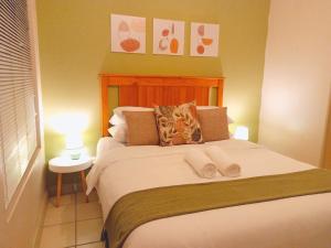 a bedroom with a bed with two towels on it at Matria Nest in East London