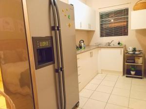 a kitchen with a stainless steel refrigerator at Matria Nest in East London