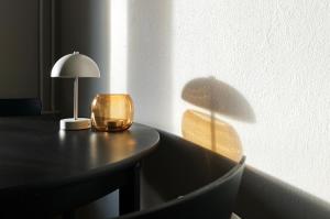 a lamp on a table with a lamp on it at Studio Violet in Pietarsaari