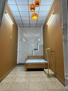 a room with a bed and a staircase with lights at Pamela Homestay in Thôn An Hòa