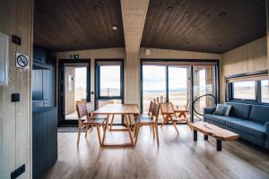 a living room with a table and chairs and a couch at Blue View Cabins in Reykholt