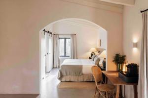 a hotel room with a bed and a desk and a desk at Finca Serena Mallorca, Small Luxury Hotels in Montuiri