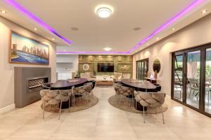 a living room with two tables and a fireplace at Braham Lodge - The Octave 3 in Johannesburg