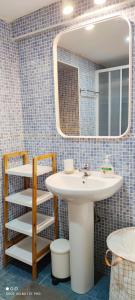 a bathroom with a sink and a mirror at Los Callejos - Casita for 4 people - 3 bedrooms in Los Callejos