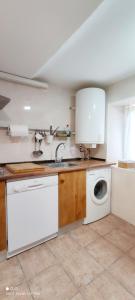 a kitchen with a sink and a washing machine at Los Callejos - Casita for 4 people - 3 bedrooms in Los Callejos +23 photos