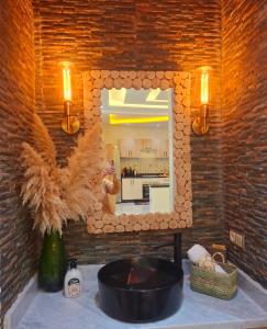 a bathroom with a mirror and a counter with a sink at Azur Apartment essaouira in Essaouira +47 photos