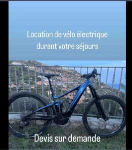 a blue bike parked next to a fence at Appartement centrale in Tende +1 photo