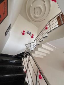 a staircase in a building with red balloons at Lotus Hotel in Kurukshetra