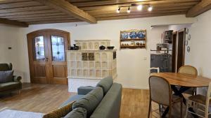 a living room with a couch and a table at Haus am Gschlößlweg in Kelheim +18 photos