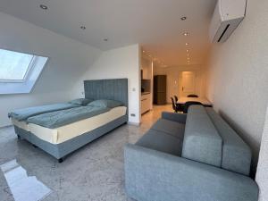 a bedroom with two beds and a couch at Gestüt Kaiserhof in Legelshurst +69 photos