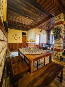 a dining room with a table and a couch at Hemisphere Boutique Farm Stay in Nagar