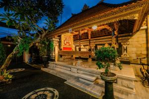 a building with a bench in front of it at Puri Kasih Home Stay in Sanur