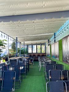 a dining room with chairs and tables in a building at Ngôi Nhà Hạnh Phúc in Plei Kêp