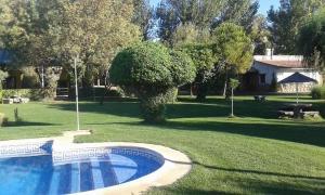 a swimming pool in the middle of a yard at Complejo rural la Badia in Lucillos +14 photos