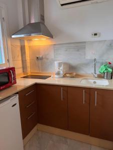 a kitchen with a sink and a counter top at Estudio superior con vistas y pequeña terraza en Maro in Maro