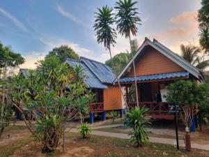 a house with solar panels on the roof at Sunny House Garden in Phra Ae beach