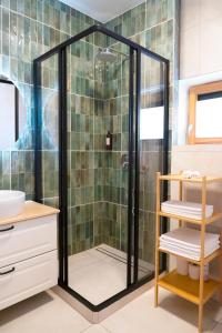 a shower with a glass door in a bathroom at Kaunas Old Town Apartment in Kaunas