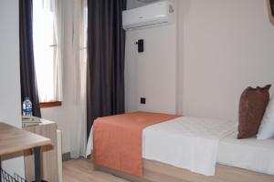 a hotel room with a bed and a window at Akkan Hotel in Bodrum City +37 photos