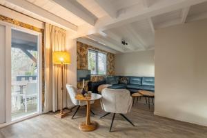 a living room with a couch and a table at Erve Dennenoord in Vasse