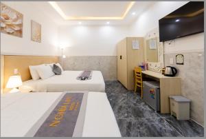 Postel nebo postele na pokoji v ubytování Nghia Lan Hotel
