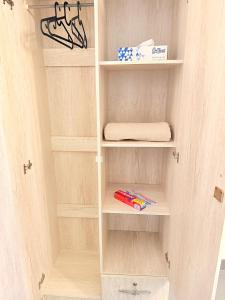 a closet with white shelves and a towel at Orchid International in Abu Dhabi +22 photos