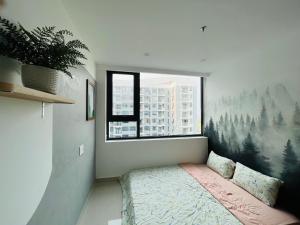 a bedroom with a large window and a bed in a room at An homestay, apartment Nera Huế in Thôn Văn Dương +73 photos