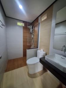 a bathroom with a white toilet and a sink at Sunny House Garden in Phra Ae beach +25 photos
